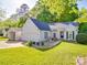 Charming single-story home with attached garage, features manicured lawn and quaint garden at 1715 Colin Creek Ln, Charlotte, NC 28214