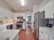 Modern kitchen with stainless steel appliances, granite countertops, and hardwood floors, creating a stylish cooking space at 1715 Colin Creek Ln, Charlotte, NC 28214
