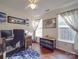 Bright home office features a computer desk, hardwood floors, and two sunny windows at 1715 Colin Creek Ln, Charlotte, NC 28214