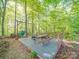 Beautiful outdoor deck with a picnic table, swing and hammocks in a woodsy backyard setting at 1715 Colin Creek Ln, Charlotte, NC 28214