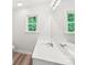 Bright bathroom with a large mirror, modern vanity, and a window with a wooded view at 185 Hunters Point Dr, Rockwell, NC 28138