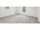Spacious bedroom with neutral carpet and two windows allowing natural light at 185 Hunters Point Dr, Rockwell, NC 28138