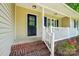 Close-up view of the front entrance showing a brick porch and black front door at 185 Hunters Point Dr, Rockwell, NC 28138