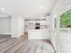 Open kitchen featuring white cabinets, stainless steel appliances, and access to the outdoor deck at 185 Hunters Point Dr, Rockwell, NC 28138