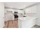 Bright, modern kitchen with stainless steel appliances, white cabinets, and quartz countertops at 185 Hunters Point Dr, Rockwell, NC 28138