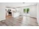 Open-concept kitchen featuring stainless appliances, white cabinets, and a breakfast bar at 185 Hunters Point Dr, Rockwell, NC 28138