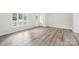 Bright living room with wood-look flooring, neutral paint, and a large window at 185 Hunters Point Dr, Rockwell, NC 28138