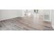 Open-concept living space with wood-look flooring, connecting to the kitchen and outdoor area at 185 Hunters Point Dr, Rockwell, NC 28138