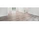 Spacious living room featuring wood-look floors and ample natural light from sliding glass door at 185 Hunters Point Dr, Rockwell, NC 28138