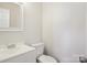 Clean half bathroom featuring white fixtures and modern design at 205 Sheffield Dr, York, SC 29745