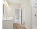 Bright bathroom with double sink vanity, shower, and door leading to bedroom with carpet at 205 Sheffield Dr, York, SC 29745