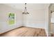 Formal dining room featuring a modern chandelier, window, and hardwood floors at 205 Sheffield Dr, York, SC 29745