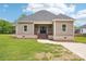 Charming single-story home featuring a covered porch and a well-manicured front lawn at 205 Sheffield Dr, York, SC 29745