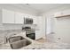 Bright kitchen featuring granite countertops, stainless steel appliances, and white cabinetry at 205 Sheffield Dr, York, SC 29745