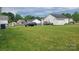 Expansive backyard featuring green grass, a car, outbuilding, and a partially fenced yard at 2109 Boggs St, Lincolnton, NC 28092