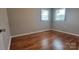 Bedroom with hardwood floors and two windows, offering a bright and inviting space at 2109 Boggs St, Lincolnton, NC 28092
