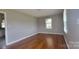 Bright bedroom showcasing beautiful wood flooring and natural light from the window at 2109 Boggs St, Lincolnton, NC 28092