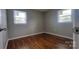 Bedroom with hardwood floors and two windows, offering a bright and inviting space at 2109 Boggs St, Lincolnton, NC 28092