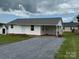 Inviting single-story home with white siding and a gravel driveway, plus a convenient carport at 2109 Boggs St, Lincolnton, NC 28092