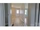 Hallway view of the interior with light-colored wood-look flooring and a white door at the end at 2109 Boggs St, Lincolnton, NC 28092