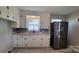 Modern kitchen featuring granite countertops, updated cabinets, backsplash, and stainless steel refrigerator at 2109 Boggs St, Lincolnton, NC 28092