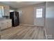 Well-lit kitchen showcasing stainless steel appliances, white cabinets, and a door to the exterior at 2109 Boggs St, Lincolnton, NC 28092