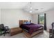 Vaulted ceiling bedroom with a wooden bed frame, a ceiling fan, and a window overlooking the backyard at 244 Whitesides Rd, Bessemer City, NC 28016
