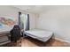 Spare bedroom with hardwood floors, a bed frame, a desk with a gaming chair, and a window for natural light at 244 Whitesides Rd, Bessemer City, NC 28016