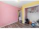 Bright bedroom featuring pink and yellow walls, wood-look flooring, and a closet with decor at 244 Whitesides Rd, Bessemer City, NC 28016