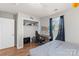 Spare bedroom with hardwood floors, a bed frame, a desk with a gaming chair, closet space, and a window at 244 Whitesides Rd, Bessemer City, NC 28016