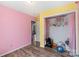 ' bedroom with hardwood floors, colorful walls, and a loaded closet at 244 Whitesides Rd, Bessemer City, NC 28016