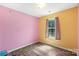 ' bedroom with hardwood floors, colorful walls, and a window offering natural light at 244 Whitesides Rd, Bessemer City, NC 28016
