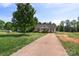 Quaint home with long driveway and well-manicured lawn and garden showcasing simple curb appeal at 244 Whitesides Rd, Bessemer City, NC 28016