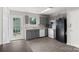 Well-lit kitchen featuring gray cabinets, white appliances, and access to the backyard through a glass door at 244 Whitesides Rd, Bessemer City, NC 28016