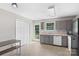 Bright eat-in kitchen with white appliances, gray cabinetry, vinyl flooring, and backyard access at 244 Whitesides Rd, Bessemer City, NC 28016