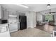 Cozy kitchen featuring gray cabinets, white appliances, and an open floor plan leading to the living area at 244 Whitesides Rd, Bessemer City, NC 28016
