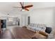Cozy living room with hardwood floors, ceiling fan, and open floor plan, leading into the kitchen at 244 Whitesides Rd, Bessemer City, NC 28016