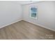 A bright bedroom with wood flooring and a window that allows natural light to stream in at 250 Marinna Joy Cir, Rockwell, NC 28138