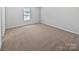 A bedroom with neutral carpet, white walls, and a window bringing in natural light at 250 Marinna Joy Cir, Rockwell, NC 28138