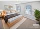 Bright bedroom with a king bed, dual windows, and neutral-toned décor at 250 Marinna Joy Cir, Rockwell, NC 28138
