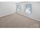 This bedroom features neutral walls and carpet, and two windows at 250 Marinna Joy Cir, Rockwell, NC 28138