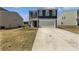 Two-story home with a two-car garage, concrete driveway, and a well-manicured lawn at 250 Marinna Joy Cir, Rockwell, NC 28138