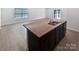 A large kitchen island features a granite countertop and stainless steel sink at 250 Marinna Joy Cir, Rockwell, NC 28138