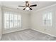 Comfortable bedroom with ceiling fan, neutral carpet, and shuttered windows at 2506 Breuster Dr, Charlotte, NC 28210
