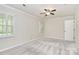 Airy bedroom featuring neutral carpet, ceiling fan, and shuttered windows at 2506 Breuster Dr, Charlotte, NC 28210