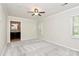 Spacious bedroom with ceiling fan, neutral carpet, and ensuite bathroom at 2506 Breuster Dr, Charlotte, NC 28210
