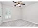 Inviting bedroom with ceiling fan, neutral carpet, and shuttered windows at 2506 Breuster Dr, Charlotte, NC 28210