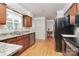 Bright kitchen showcasing stainless steel appliances, wood floors, and granite countertops at 2506 Breuster Dr, Charlotte, NC 28210