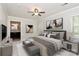 Calm bedroom featuring a ceiling fan, neutral walls, decorative wall art, and an en-suite bathroom at 2506 Breuster Dr, Charlotte, NC 28210