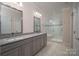 Bathroom featuring double vanity with granite countertop and glass enclosed shower with bench at 286 Hemlock Bluff Ct, Denver, NC 28037